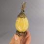 Яйцо из янтаря в бронзе с коршуном на подставке - высота 11 см